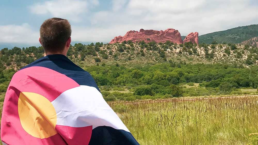 Man wearing Colorado flag in Garden of the Gods