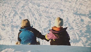 two kids sledding