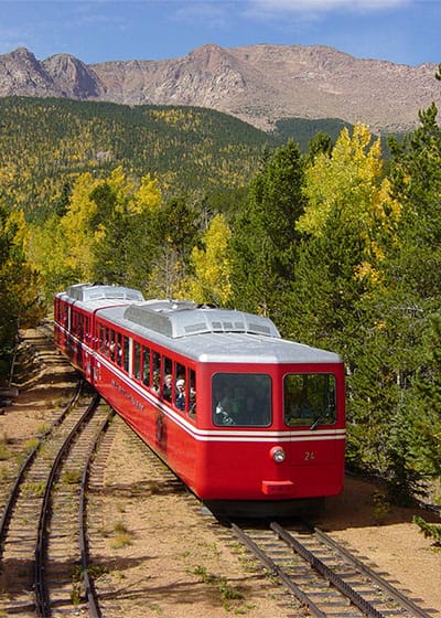 The Pikes Peak Cog Railway with fall colors in the background