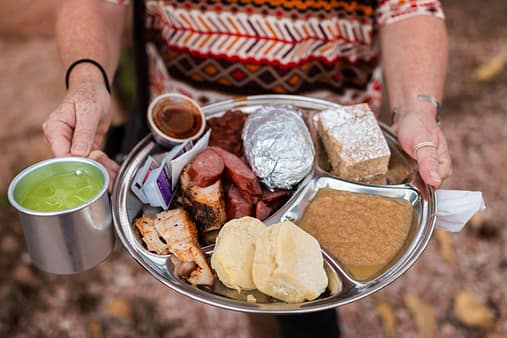 A person displays a plate filled with food at the Flying W Ranch chuckwagon supper in Colorado Springs.