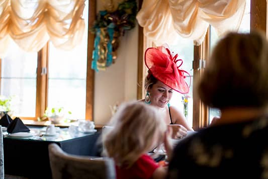 A mom sits at a table for Miramont Castle Museum mother's day tea service.