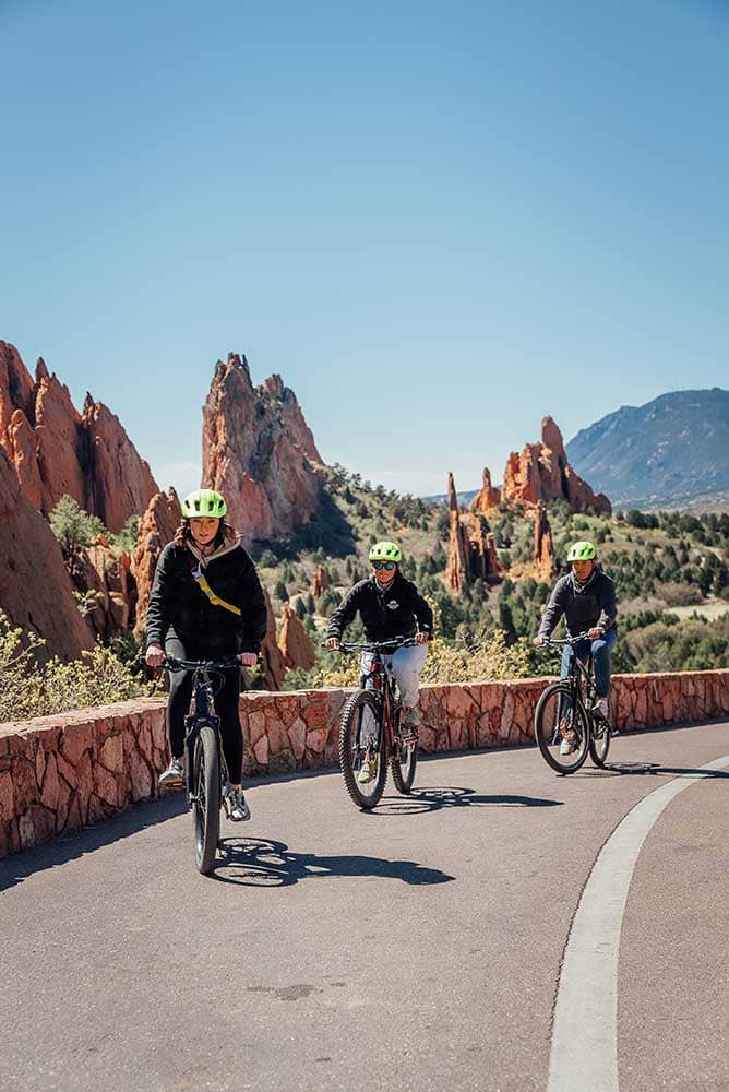 Group biking with Garden of the Gods in background