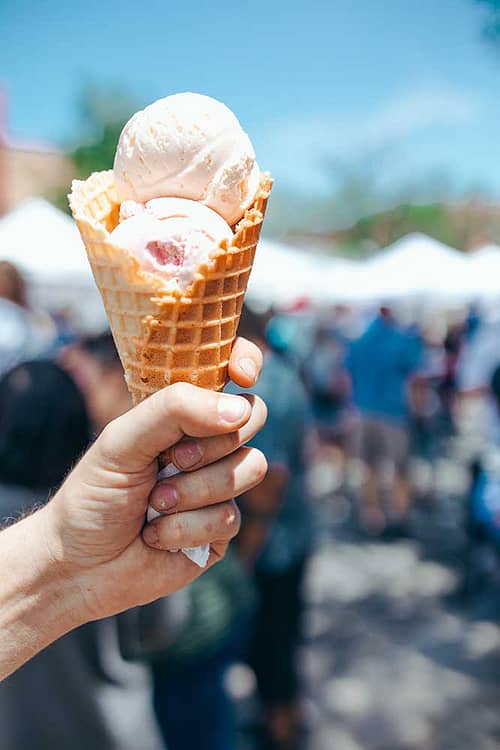 A hand holds up an ice cream cone at Territory Days.