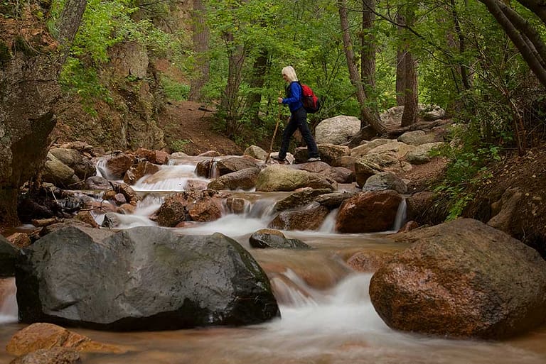 Woman hiking over river