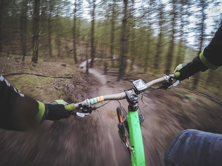 POV person riding bike on trail