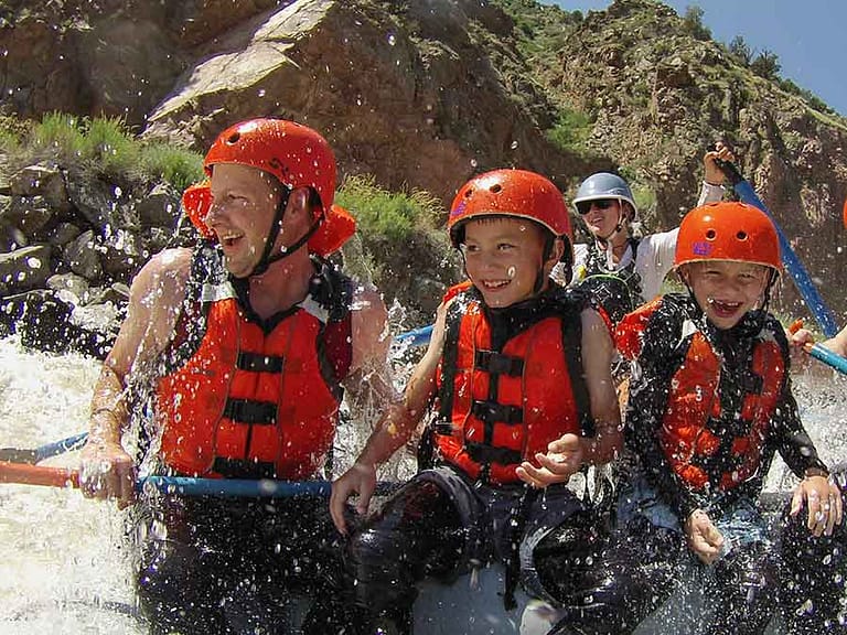Dad and kids rafting with Echo Canyon River Expeditions