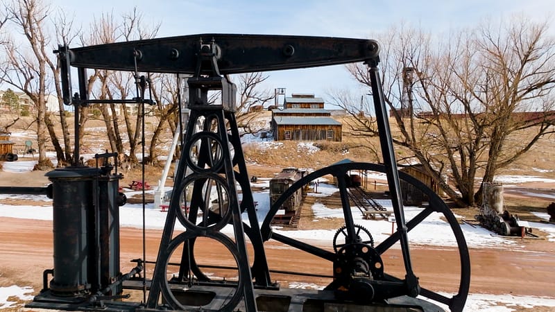 Outdoor machinery at the Western Museum of Mining & Industry during winter.