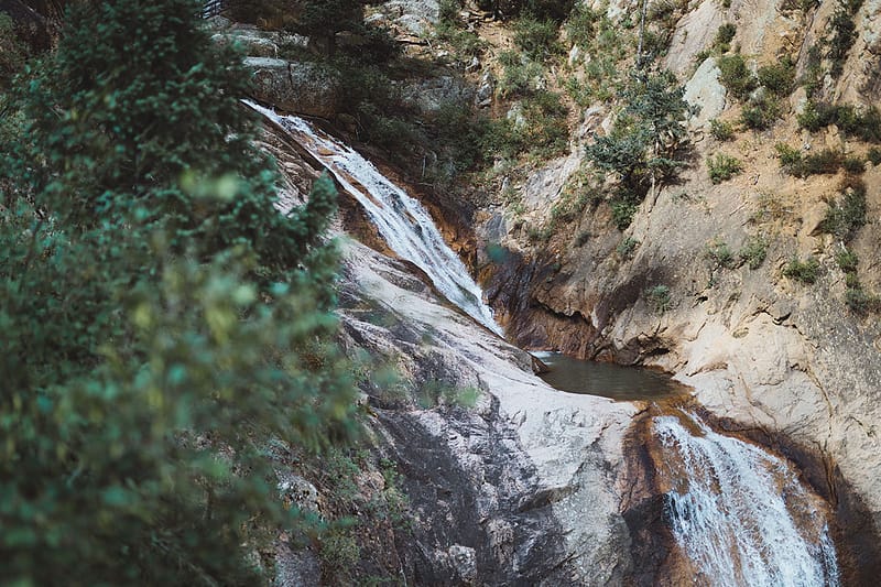A waterfall crashes down through the canyon.