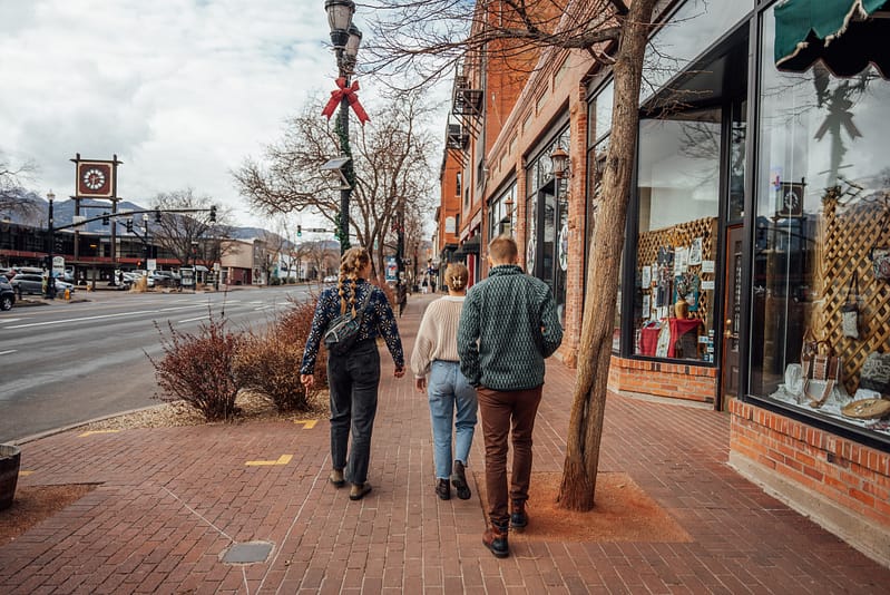 People walking on sidewalk in Old Colorado City during the winter.