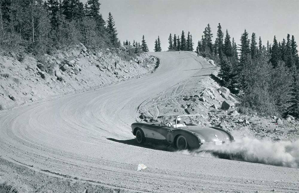 A race car ascends a gravel curve during the 1900s Pikes Peak International Hill Climb. 