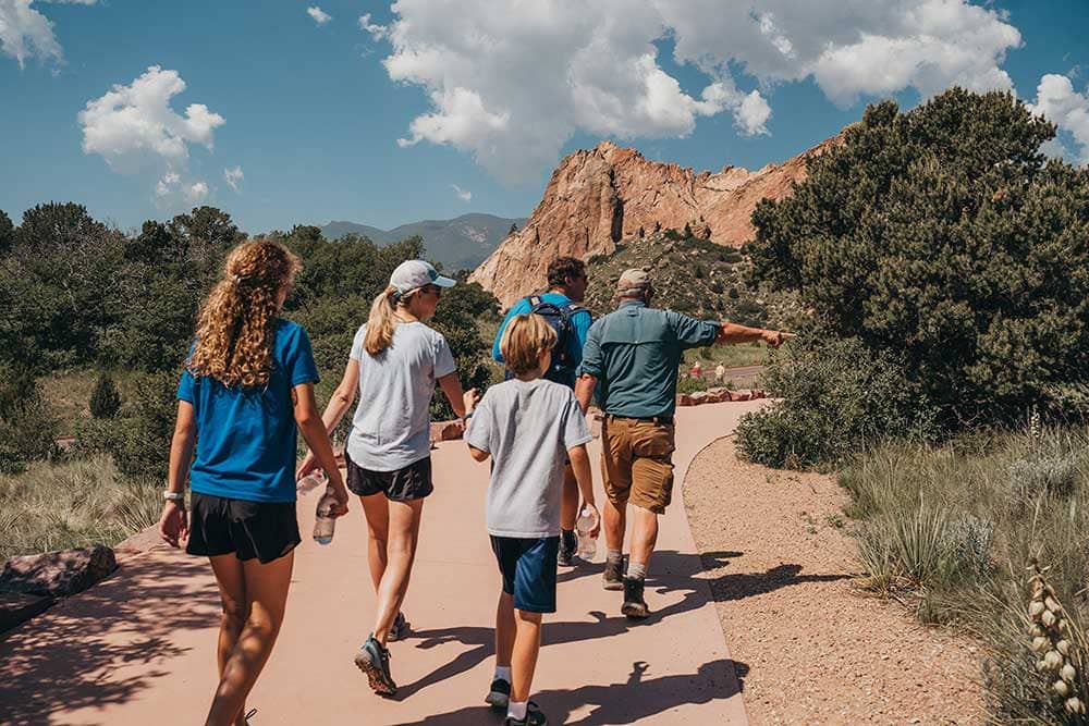 Family taking a guided hike in Garden of the Gods with Broadmoor Outfitters