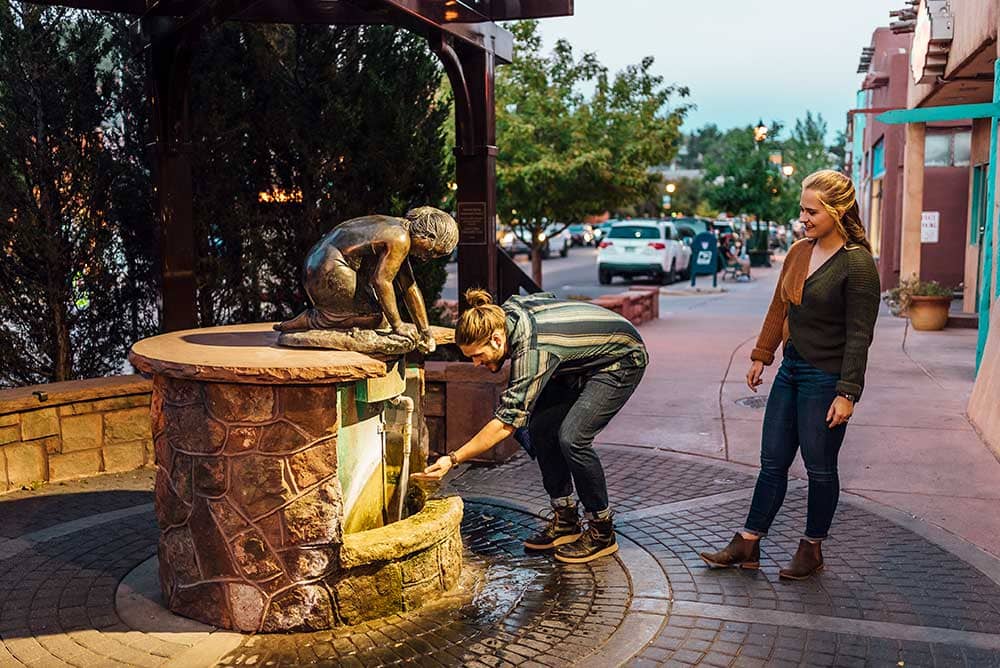 Couple getting water from Stratton Spring in Manitou Springs