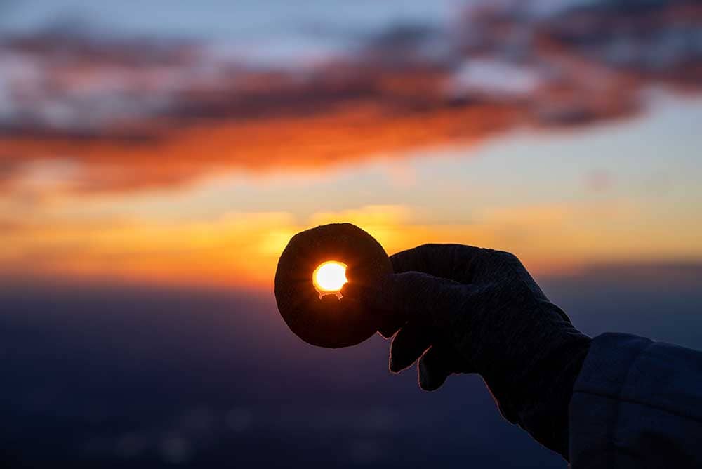 Donut with sunrise behind it on Pikes Peak