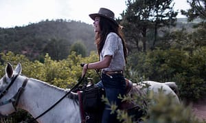 Woman riding Academy Riding Stables horse in Garden of the Gods