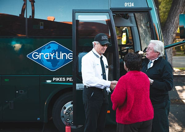 Gray line tour guide shaking hands