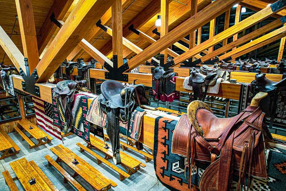 Saddles and blankets perch on beams in the Flying W Ranch Old West Collection.