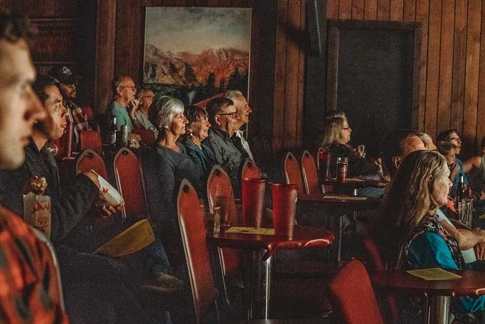 Iron Springs Chateau audience looks on as a performance unfolds.