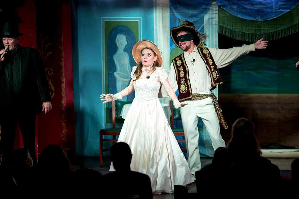 An actor and actress perform on stage at the Iron Springs Chateau.