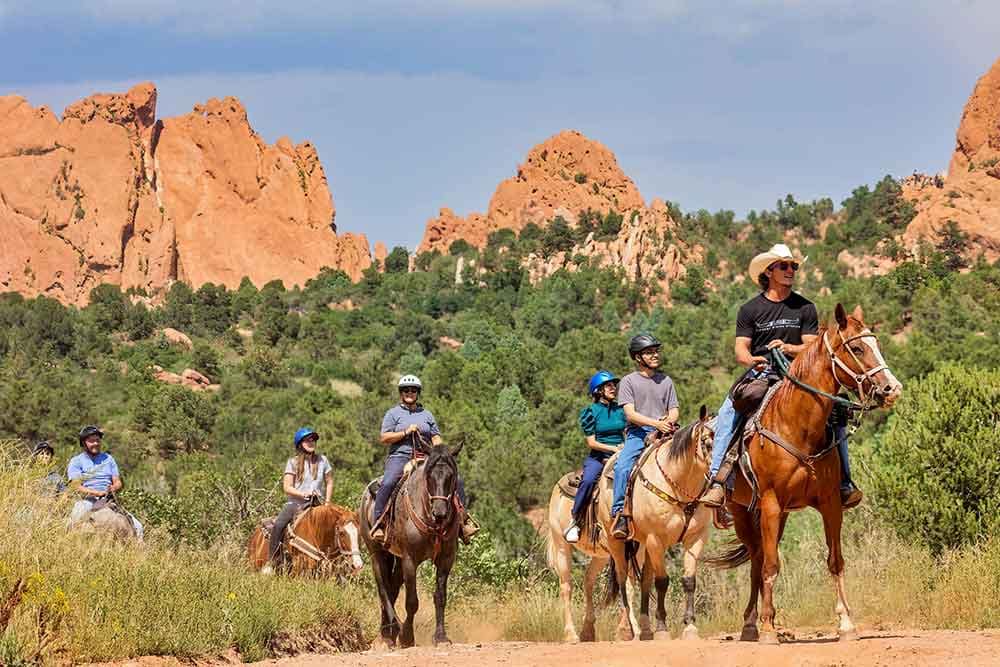 People riding horses in Garden of the Gods