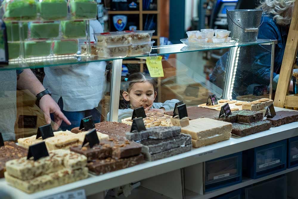 Little kid at the Garden of the Gods Trading Post fudge counter