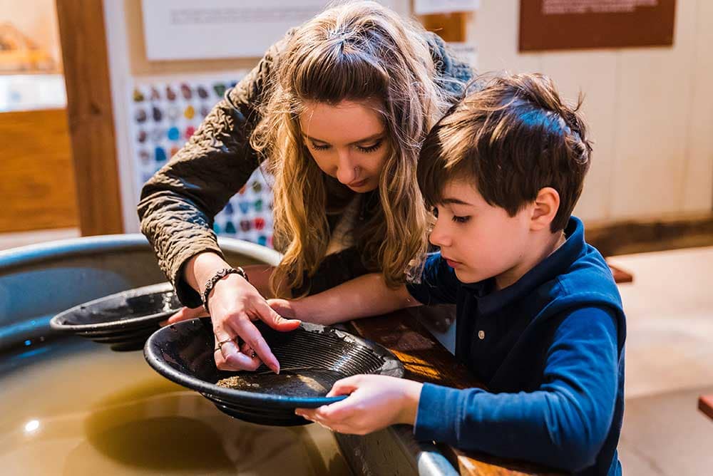Mother and son goldpanning at Western Museum of Mining and Industry.
