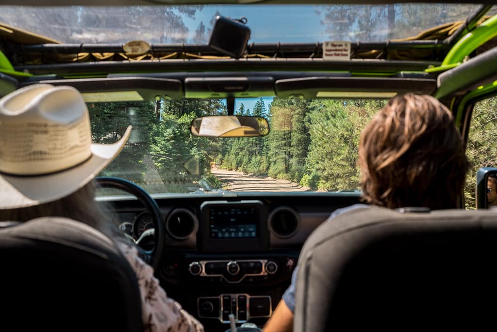 guest and guide in front seat of Adventures Out West Jeep