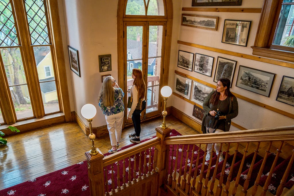 People walking on Miramont Castle staircase