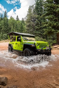Adventures Out West Jeep driving through stream