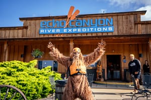 Bigfoot posing in front of Echo Canyon River Expeditions building