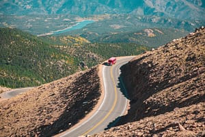 Gray Line bus turning a corner on Pikes Peak from above