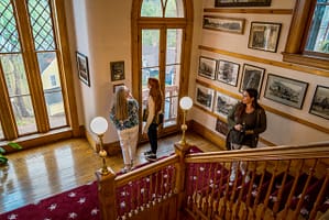 People walking on Miramont Castle staircase