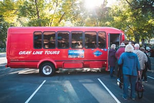 People boarding a Gray Line bus
