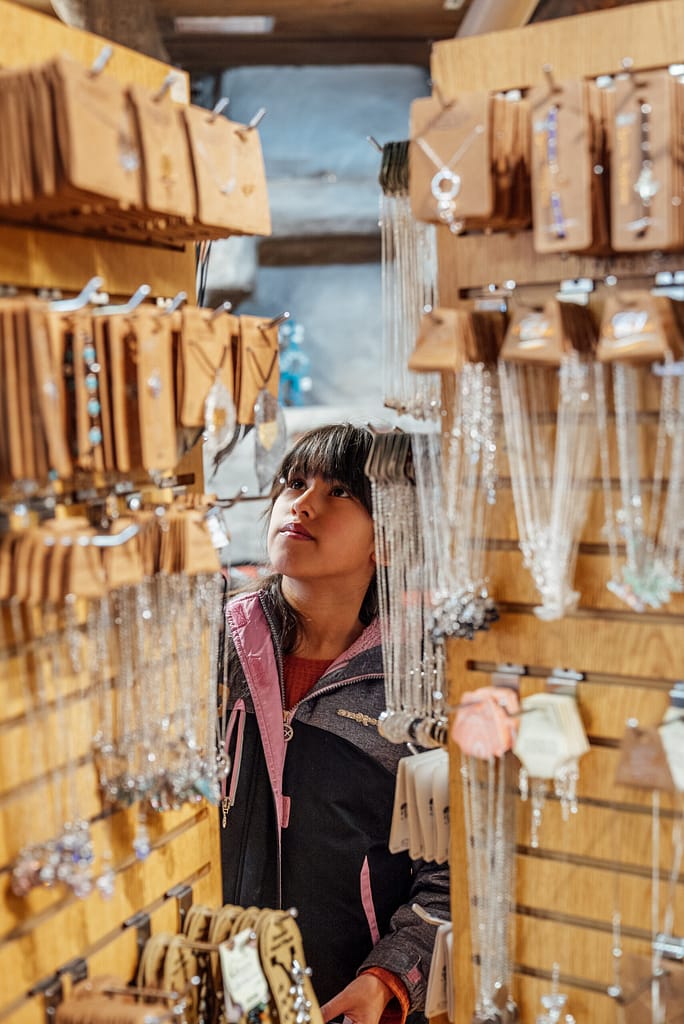 Girl looking at necklaces at the Garden of the Gods Trading Post