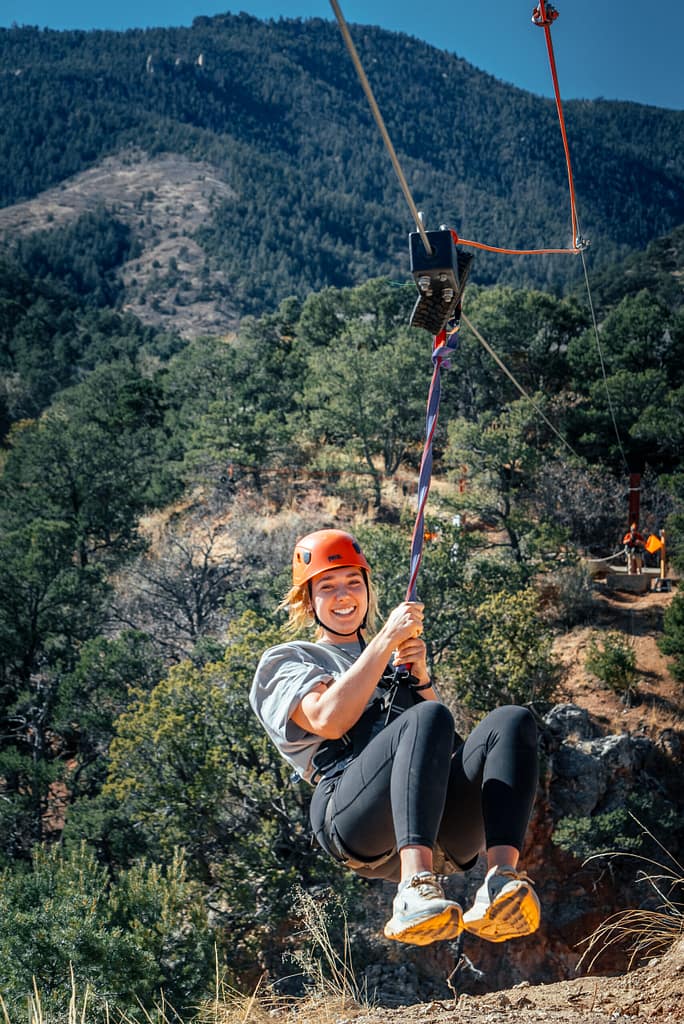Woman zip lining in Manitou Springs with Adventures Out West